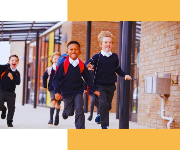Image of primary school children running to school